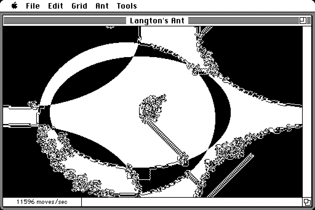 A screenshot of Langton’s ant running on a monochrome Macintosh. The ant is interacting with the edges of multiple overlapping ovals that invert one another. The ant follows some of the edges, creating trails of dislodged pixels that still reveal the underlying shapes.